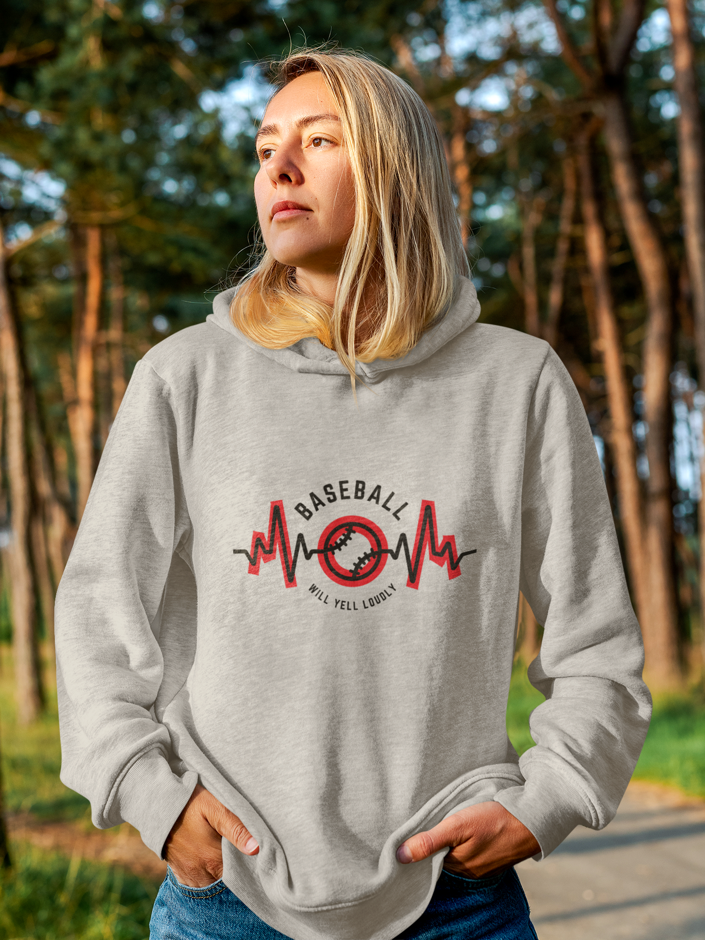 Woman with hands in pocket looking off in the distance wearing hoodie